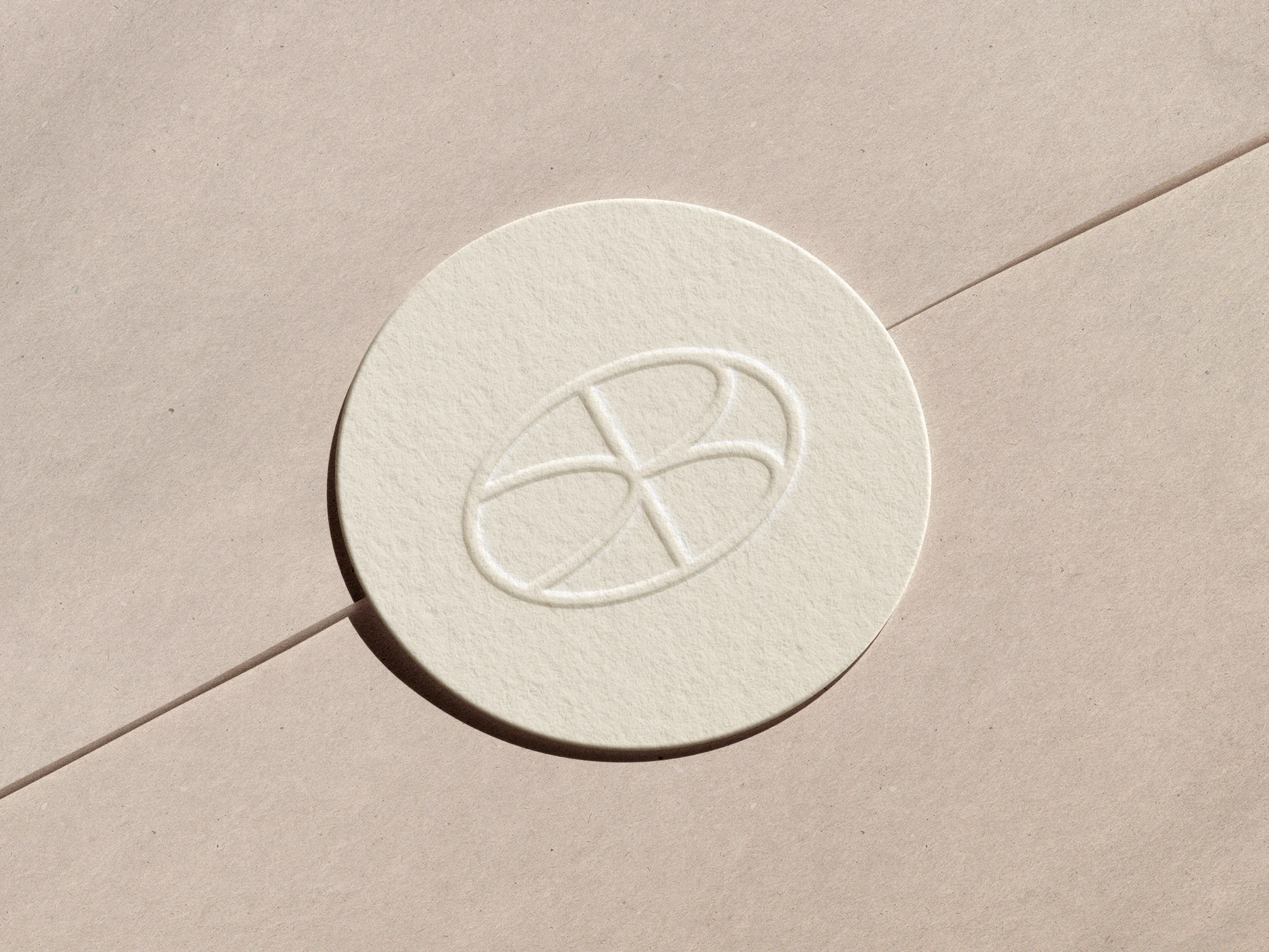 The seal blind-embossed on a cream coaster