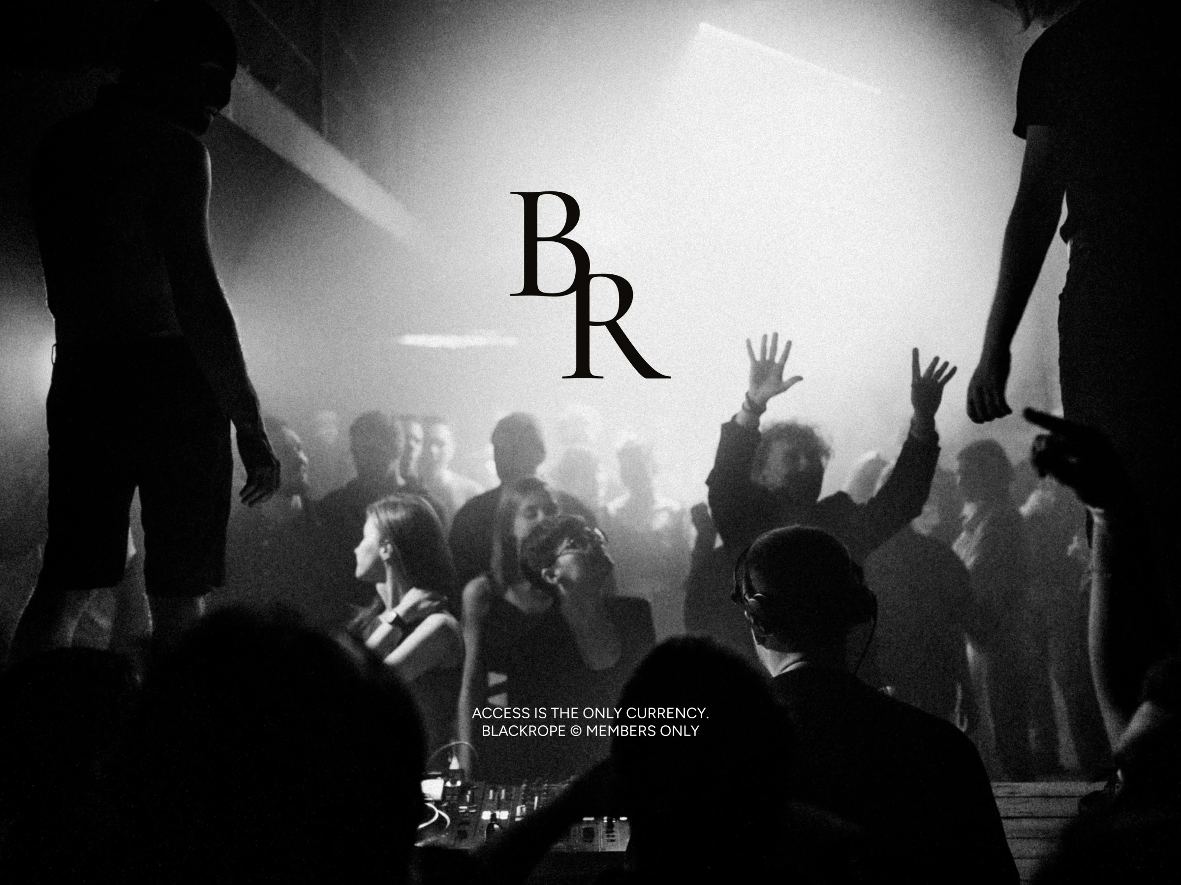 The serif monogram over a black and white crowd at a club night