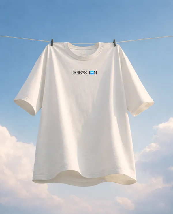 A white t-shirt on a washing line against clouds, the Digibastion wordmark across the chest