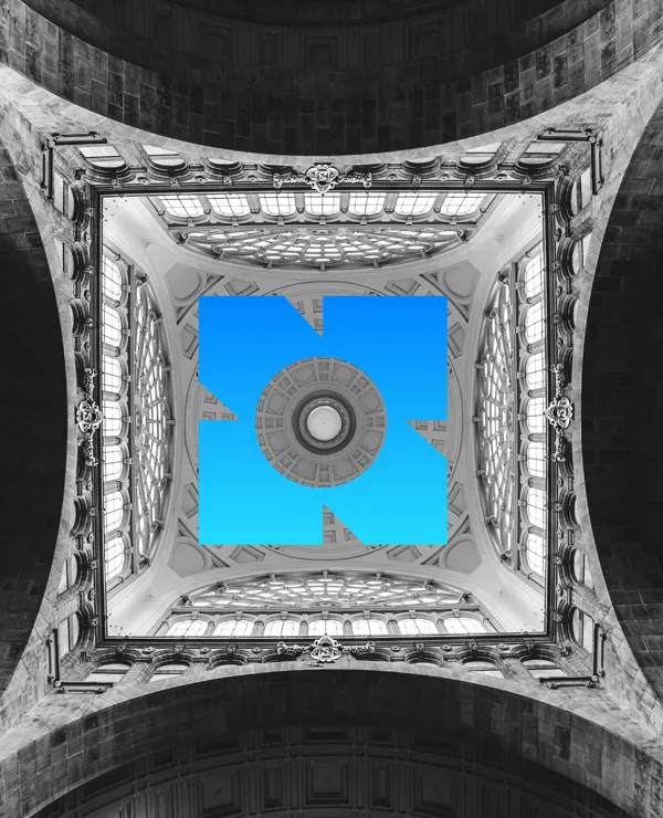 A vaulted ceiling photographed from below, the mark in blue at its centre