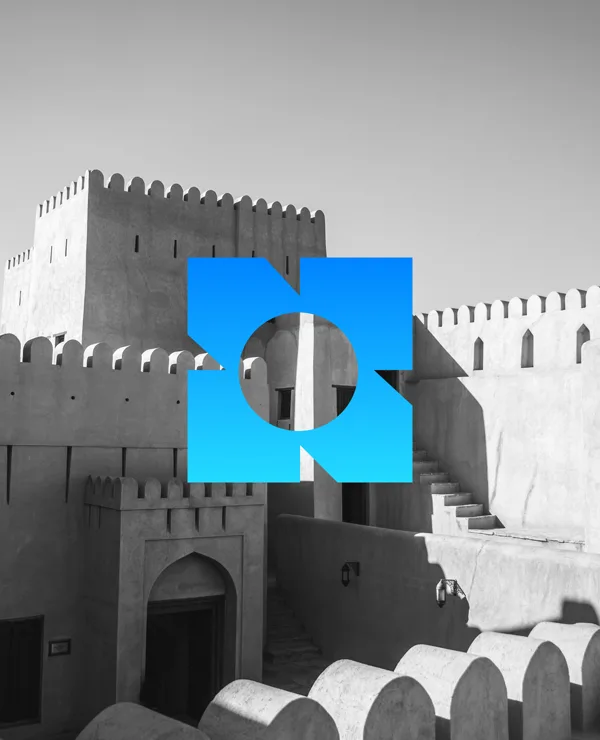 A crenellated fort in grey, the Digibastion mark in solid blue over it
